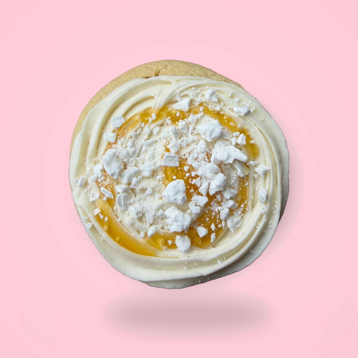 Close-up of a dessert with white cream and mango sauce on a pink background