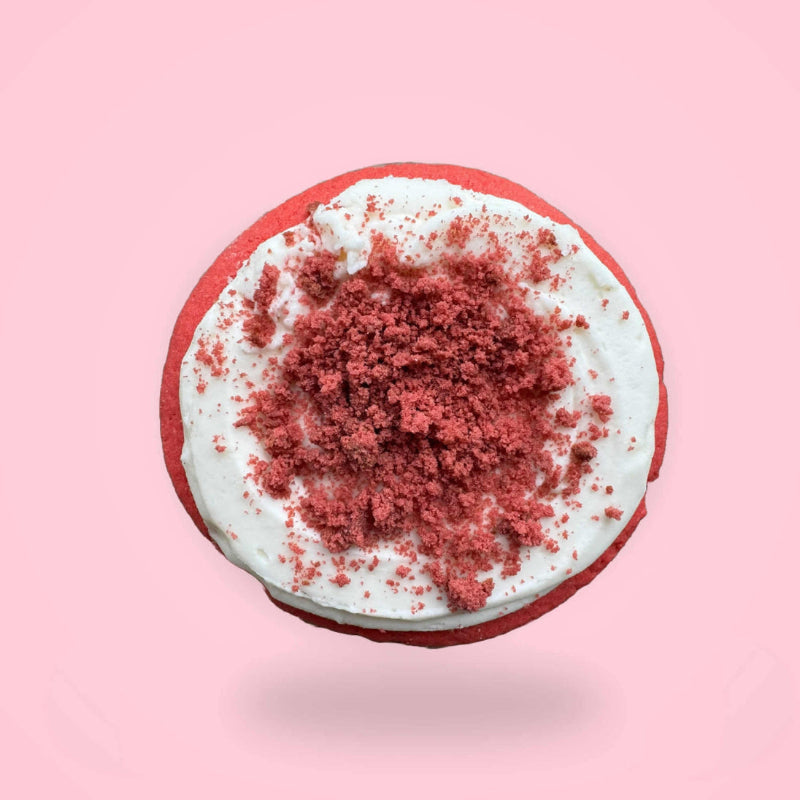 A red velvet sugar cookie on pink background